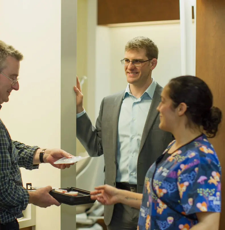 Dental Marketing Guy team consulting with dental practice owner about growth strategies